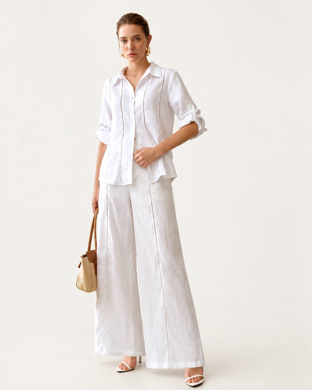 Modelo em corpo inteiro vestindo look completo com camisa de puro linho off-white e calça combinando