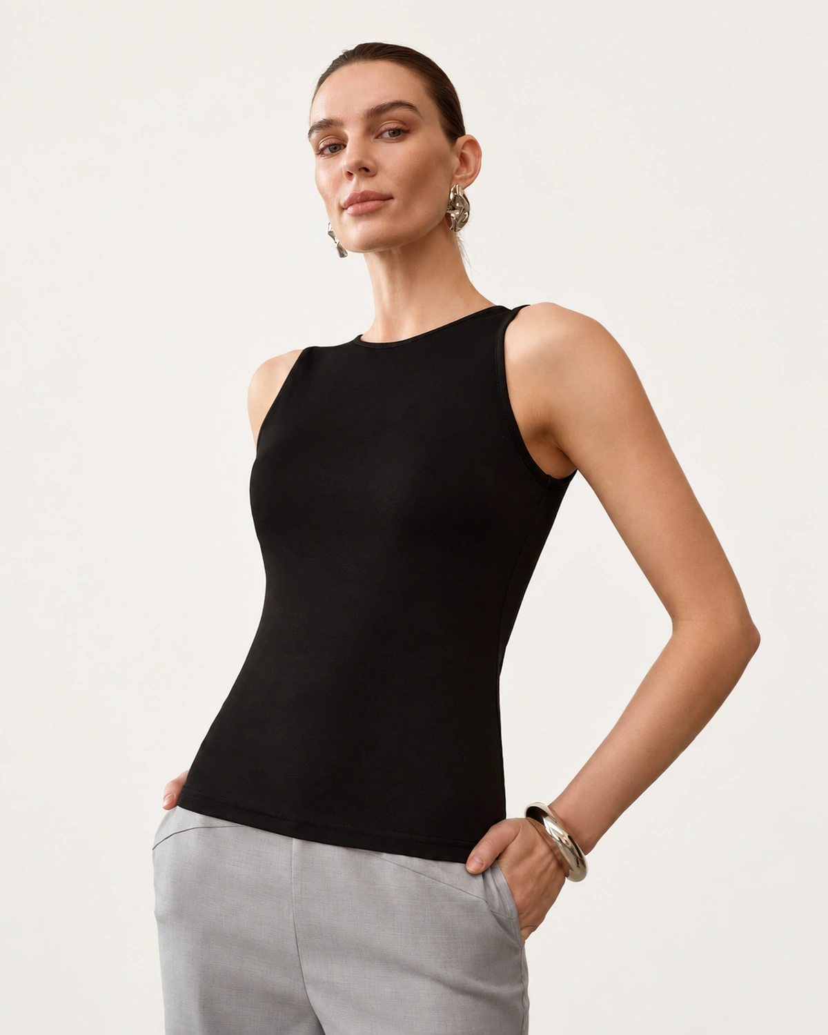 Modelo vestindo regata slim fit com gola redonda fechada na cor Noir em estúdio.